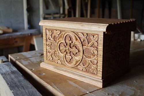 another view of the face carving on the oak bourbon glass box