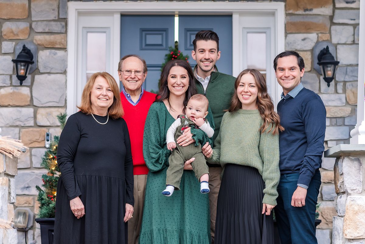 Extended family portrait on porch together in Christmas attire with Cranberry Township, PA newborn photographer