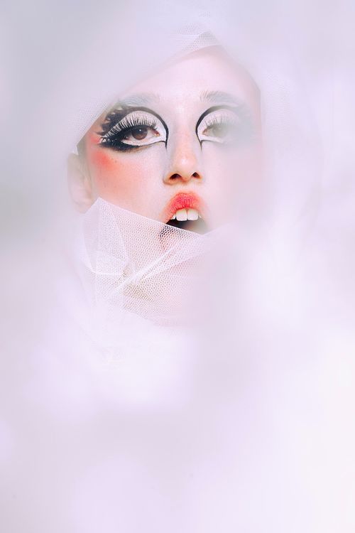 High-fashion pose with dramatic costume, studio photography by Mila Filippone.