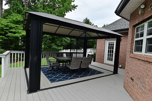 Covered patio with rectangular table and six chairs.