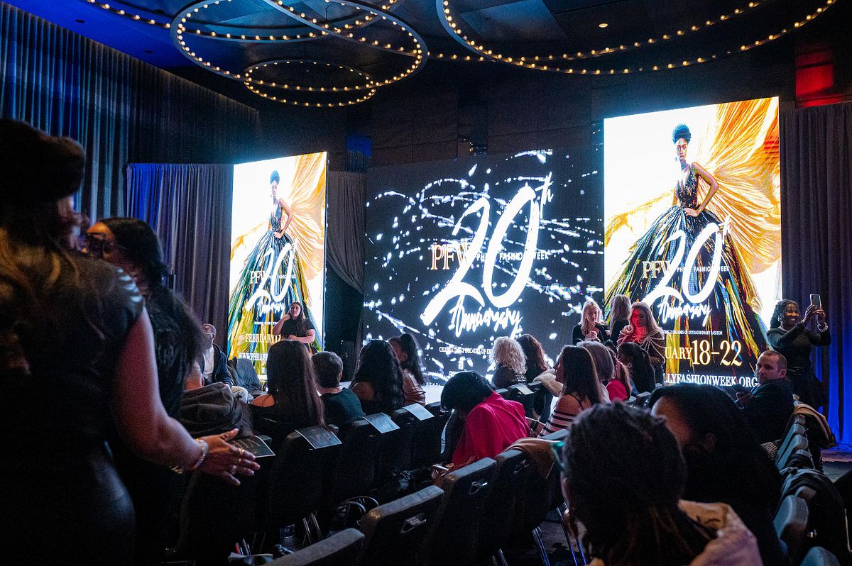 Event photography from the 20th Anniversary Philadelphia Fashion Week runway show, capturing audience anticipation, creative production design, and cultural celebration in Philadelphia.