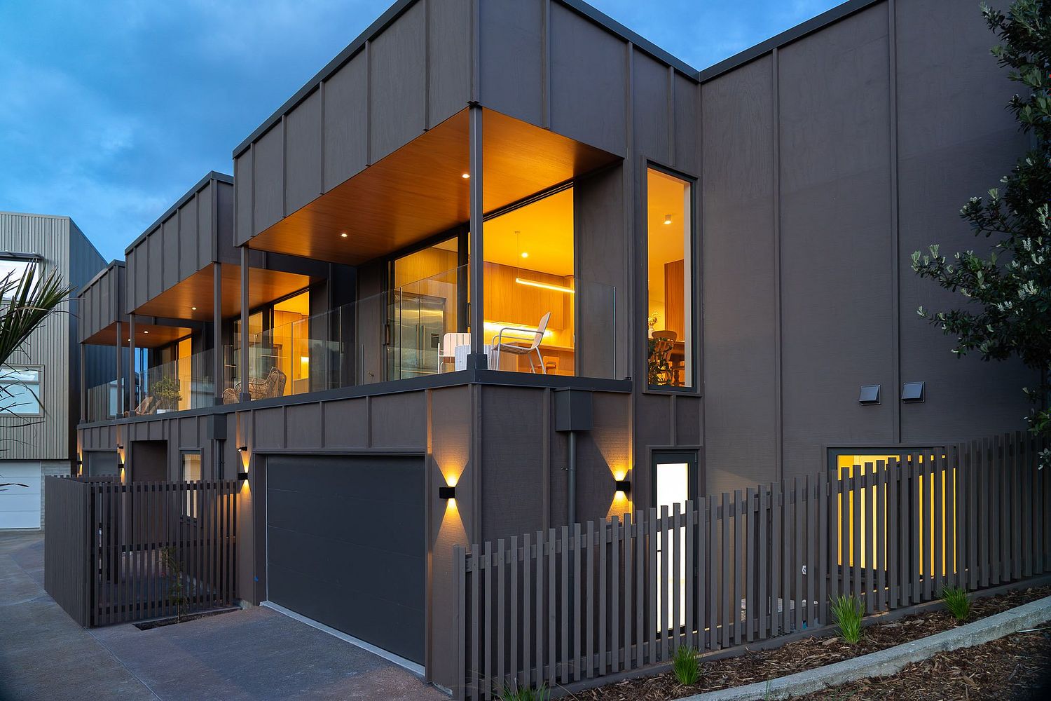 wilight architectural photography of a modern home in the West Village, Rangitahi Peninsula by Flax Cove Studio.