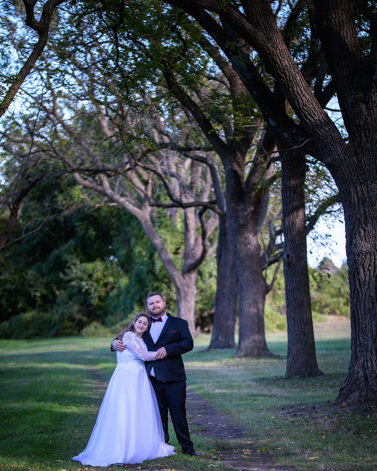 wide-angle shot of groom and bride on the grounds at ross mansion