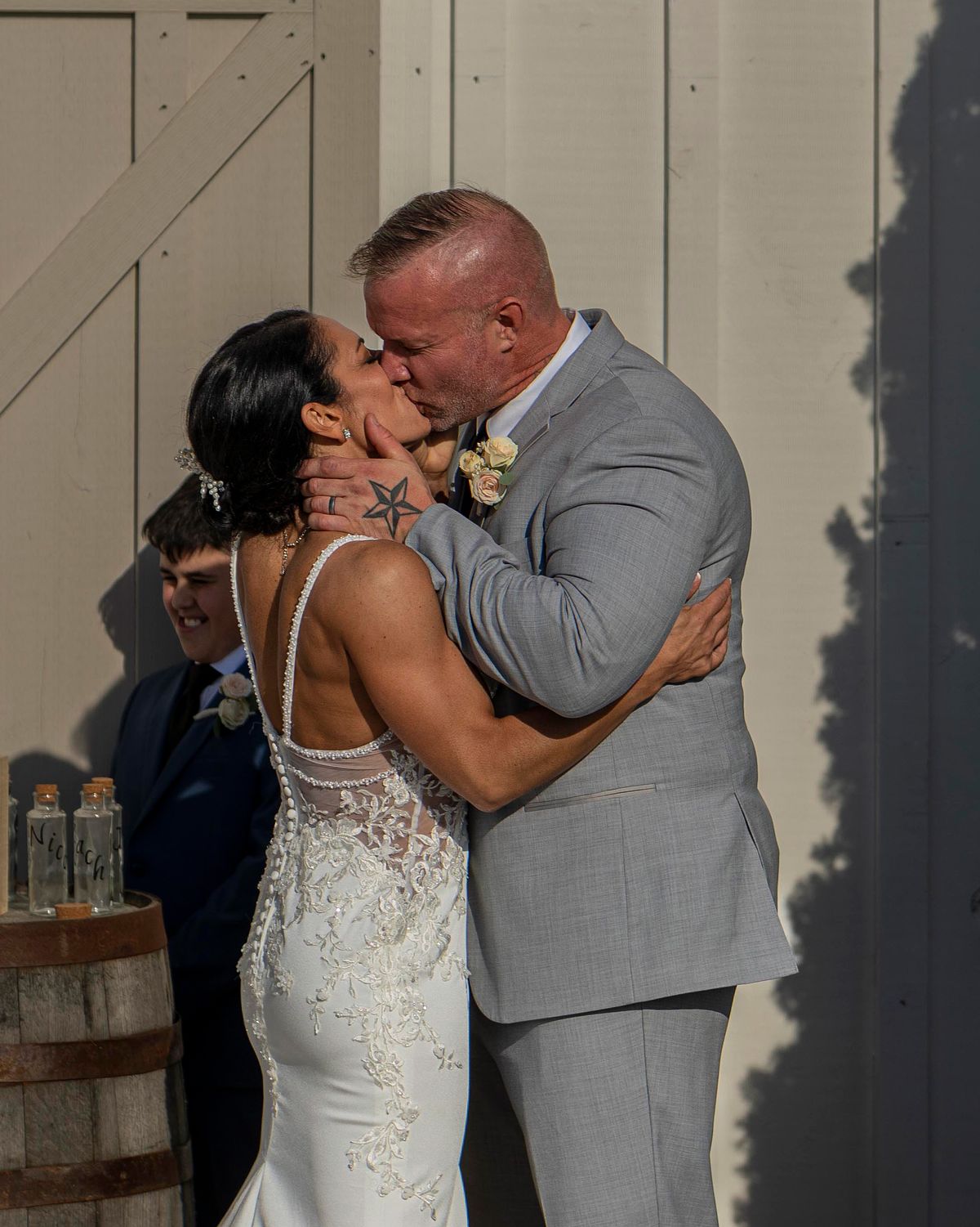 bride and groom kissing after ceremony at kylan barn
