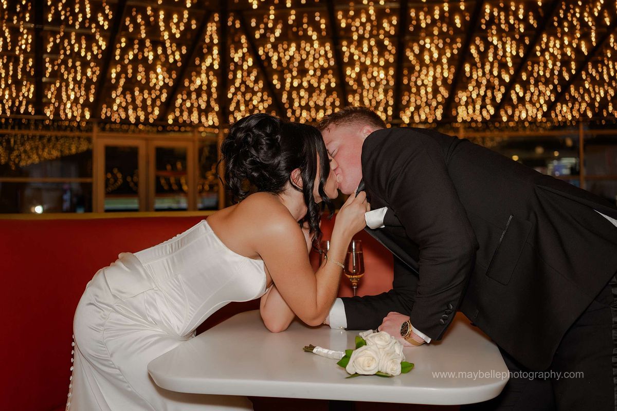 Romantic elopement photos at Carousel Bar in Downtown Las Vegas with couple celebrating with champagne