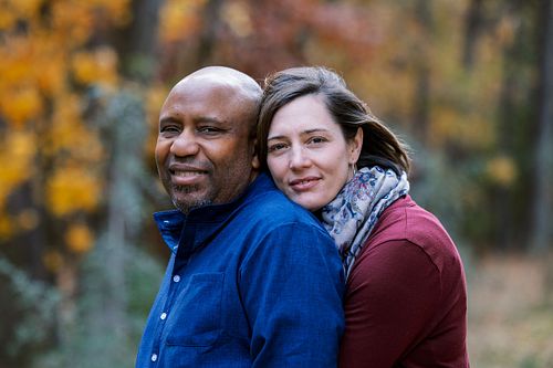 A couple photographed the fall against foliage in Dr. Martin Luther King Jr. Park in Carrboro, NC