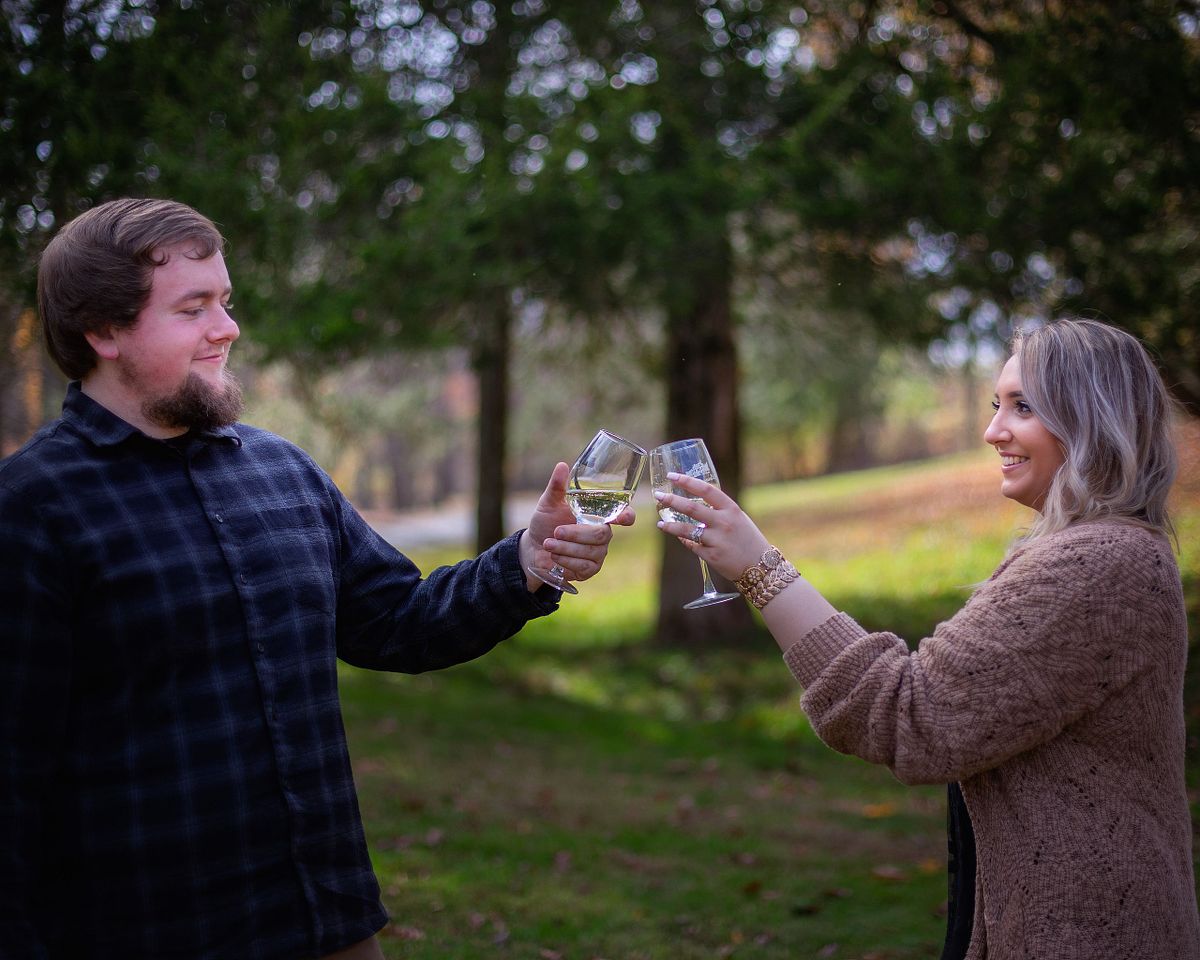 couple toasting during romantic valentine proposal near the Chesapeake bay in maryland