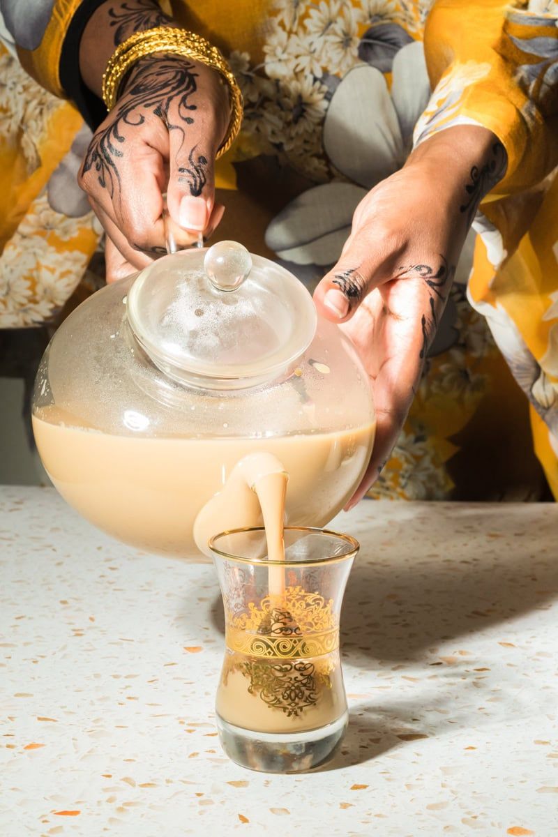 Light and airy Somali tea being poured into glass cup