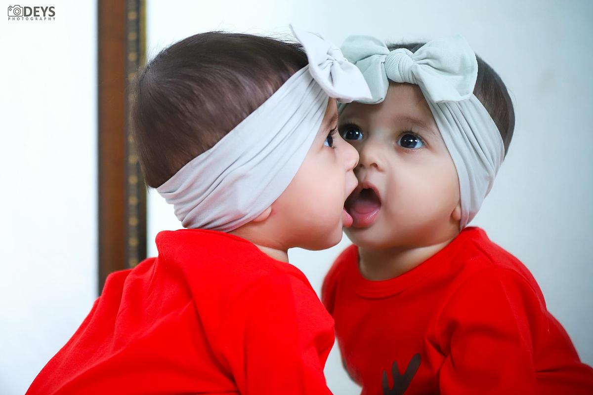 Cute baby girl looking at mirror photography