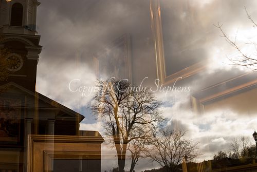 Church steeple with a mysterious gold-framed artwork in a cloudy scene on Wellesley, Massachusetts Main Street.
