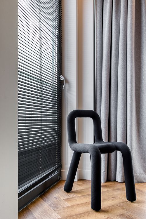 Interior detail featuring a designer chair – Azoria project