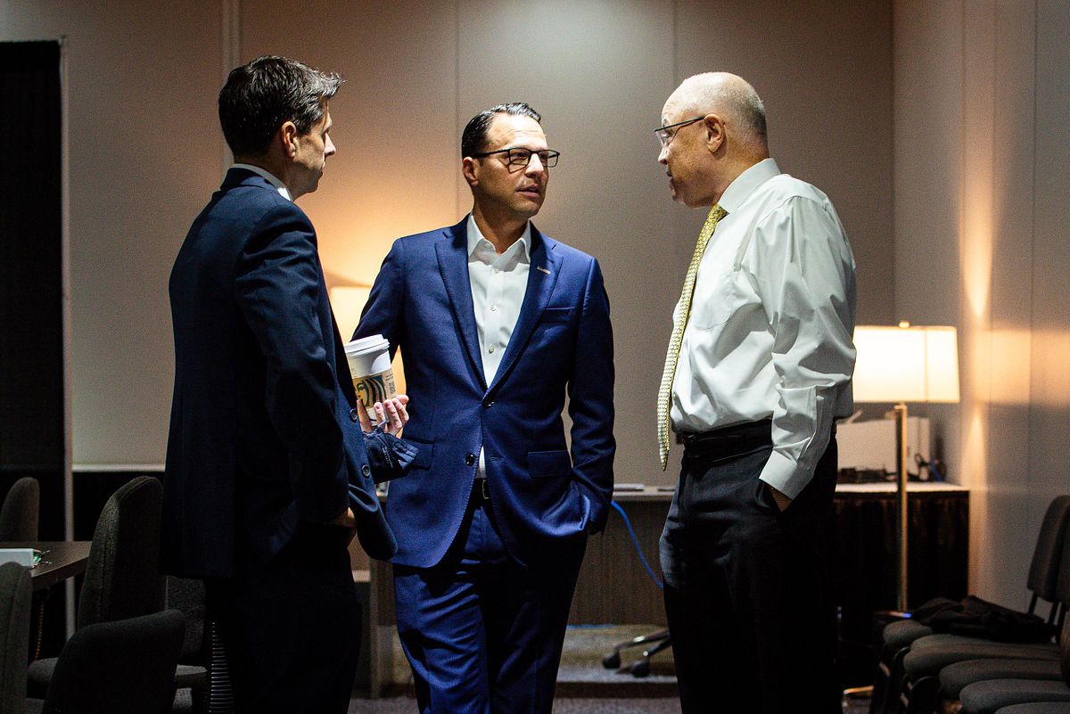 Corporate event photography capturing Governor Josh Shapiro and AFSCME President Lee Saunders in conversation backstage at the 2022 AFSCME National Convention in Philadelphia, highlighting leadership presence, connection, and advocacy.
