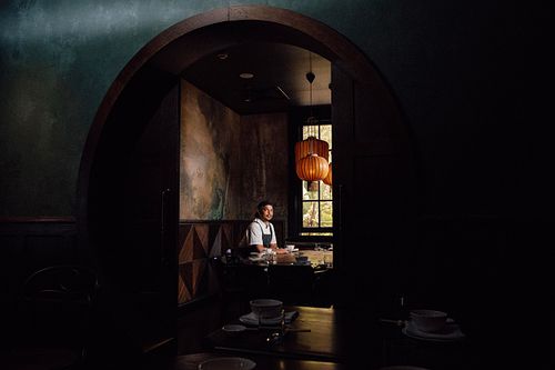 Head Chef, Louis Tikaram sits at a table at his Stanley Restaurant at Brisbane,