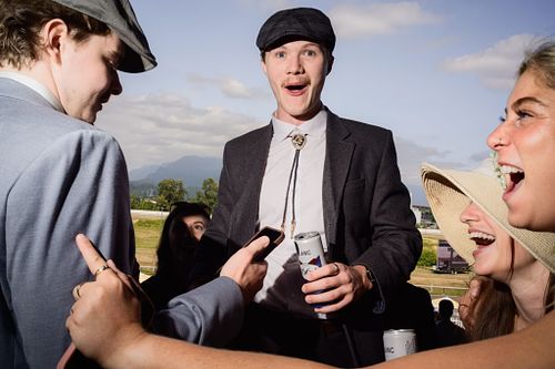 a candid photo of a crowd at a horse racing event on a summer day in Vancouver