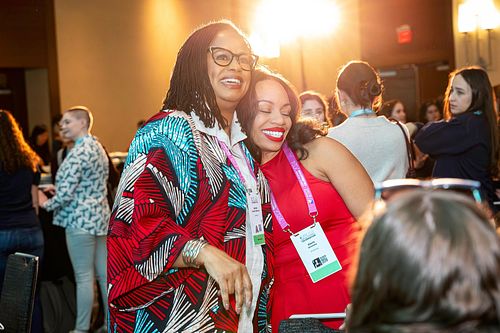 Brenda Darden Wilkerson embracing an attendee during a joyful networking moment at Grace Hopper Celebration 2024 in Philadelphia, captured by professional event photographer.