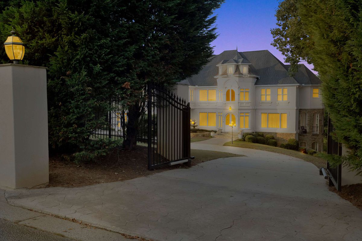 As dusk settles in Atlanta, a grand mansion comes alive with illuminating windows