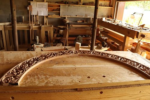 hand carved arch on workbench ready to be stained