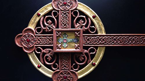 Beautifully carved leaves and knotwork and roundels on a reliquary for the True Cross for St Patrick Catholic Church in London, Ohio