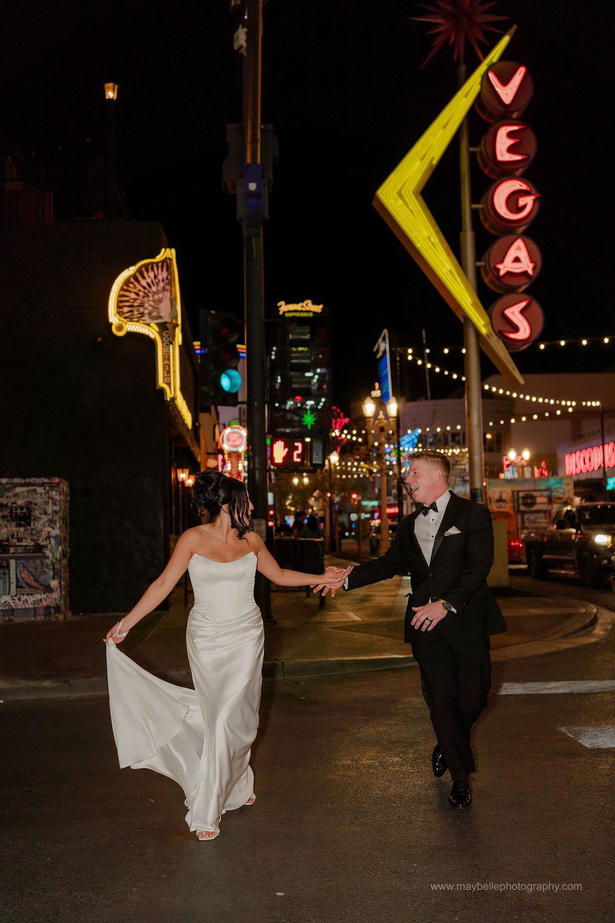 Romantic elopement photos at Carousel Bar in Downtown Las Vegas with couple celebrating with champagne