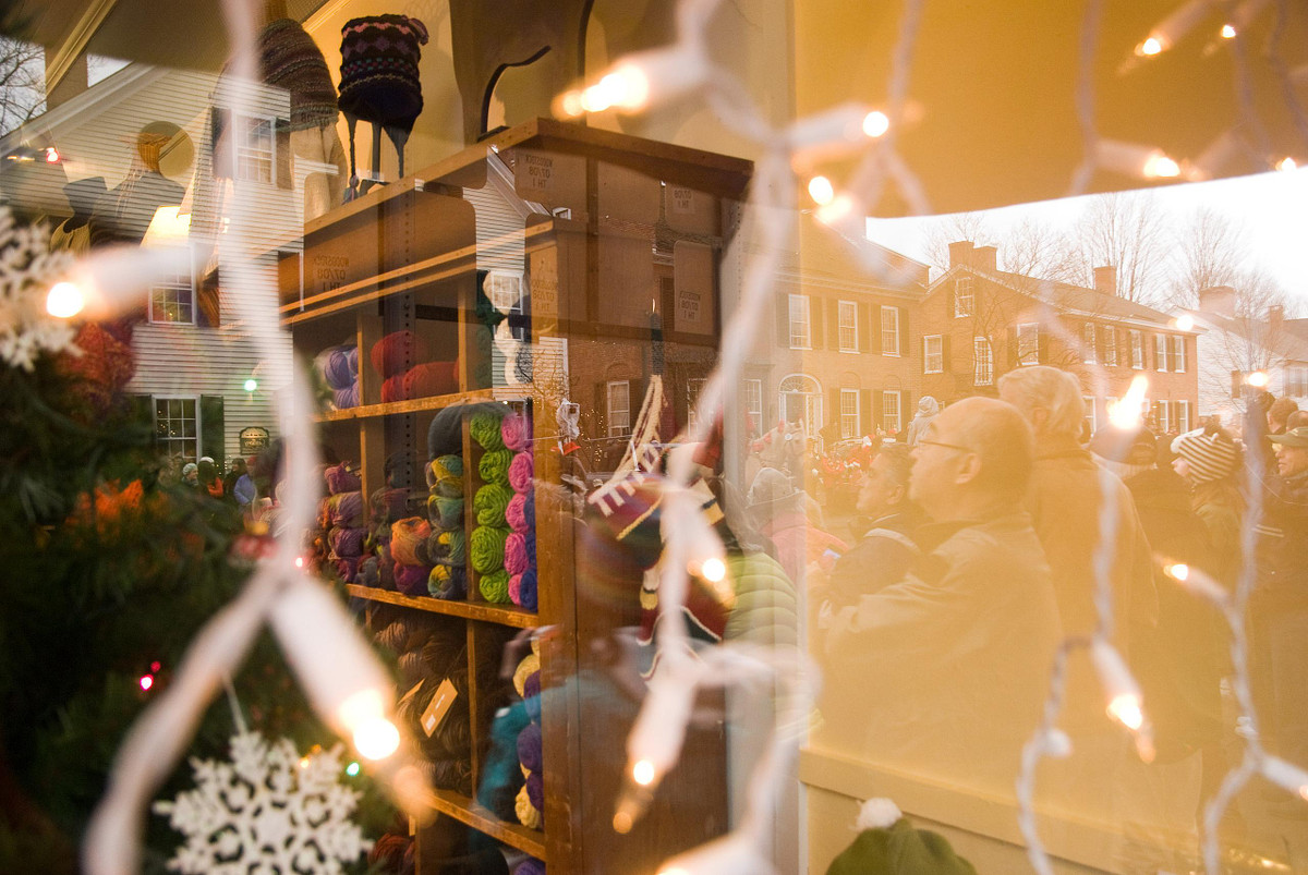 Skeins of wool juxtaposed with outside scene of parade watchers
