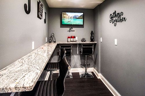 Elegant snack room featuring a stylish bar and inviting decor