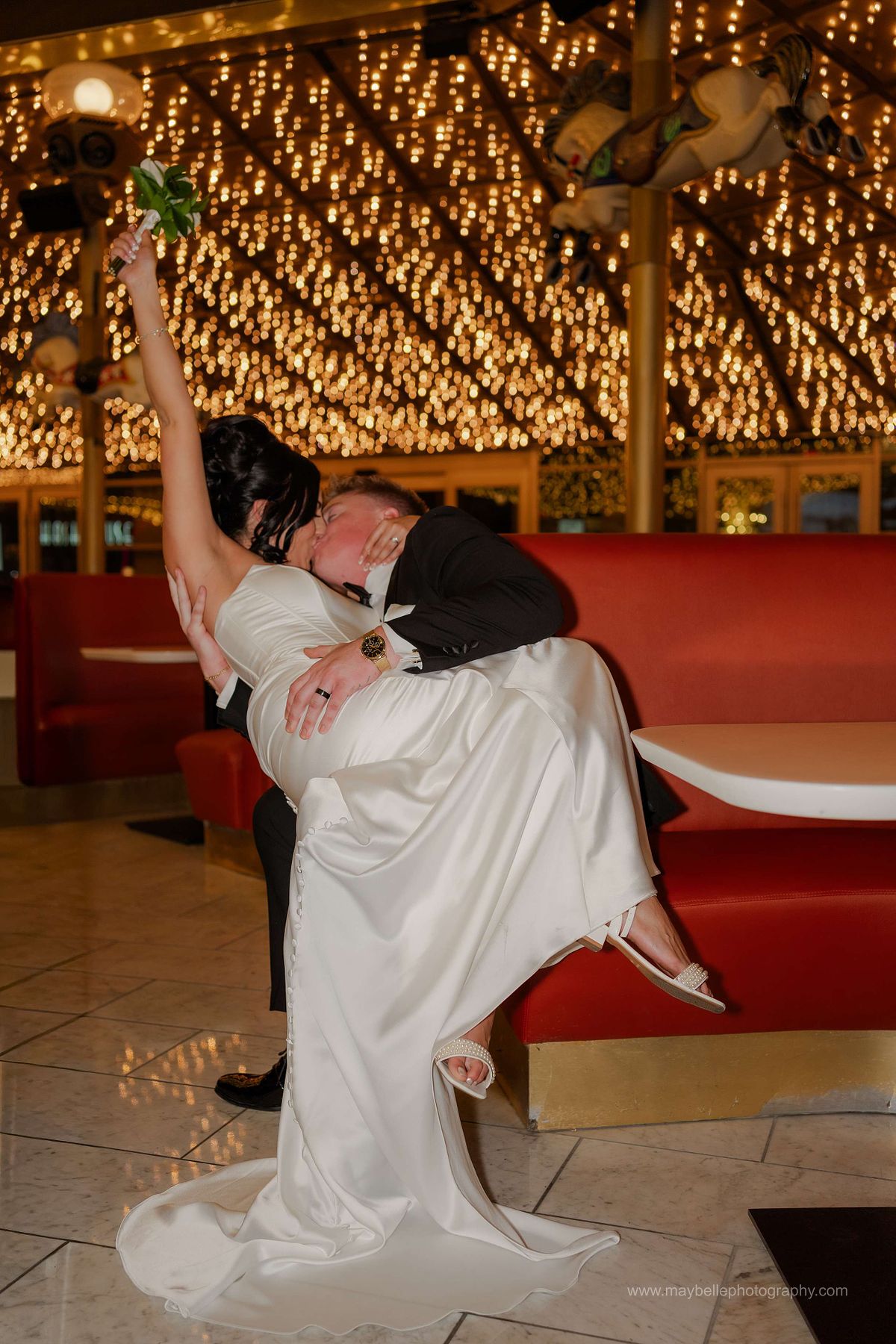 Romantic elopement photos at Carousel Bar in Downtown Las Vegas with couple celebrating with champagne