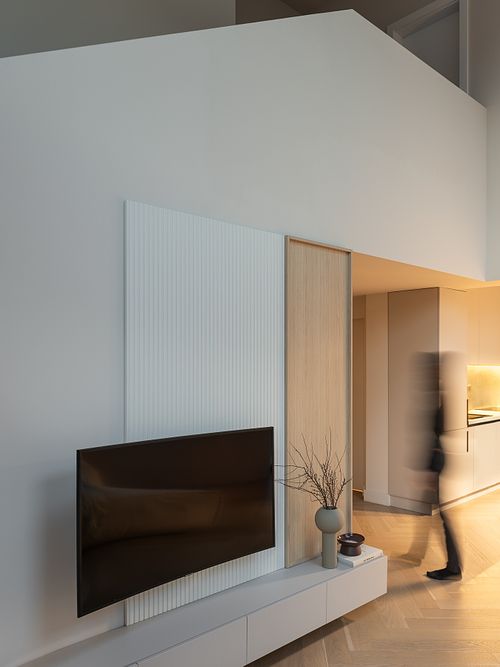 Dynamic interior photograph with subtle human presence in a minimalist setting &ndash; Faget project