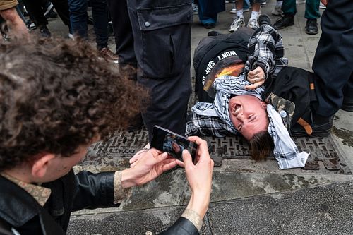 Youth Demand activists block the oncoming traffic on the junction by Marble Arch, London, UK