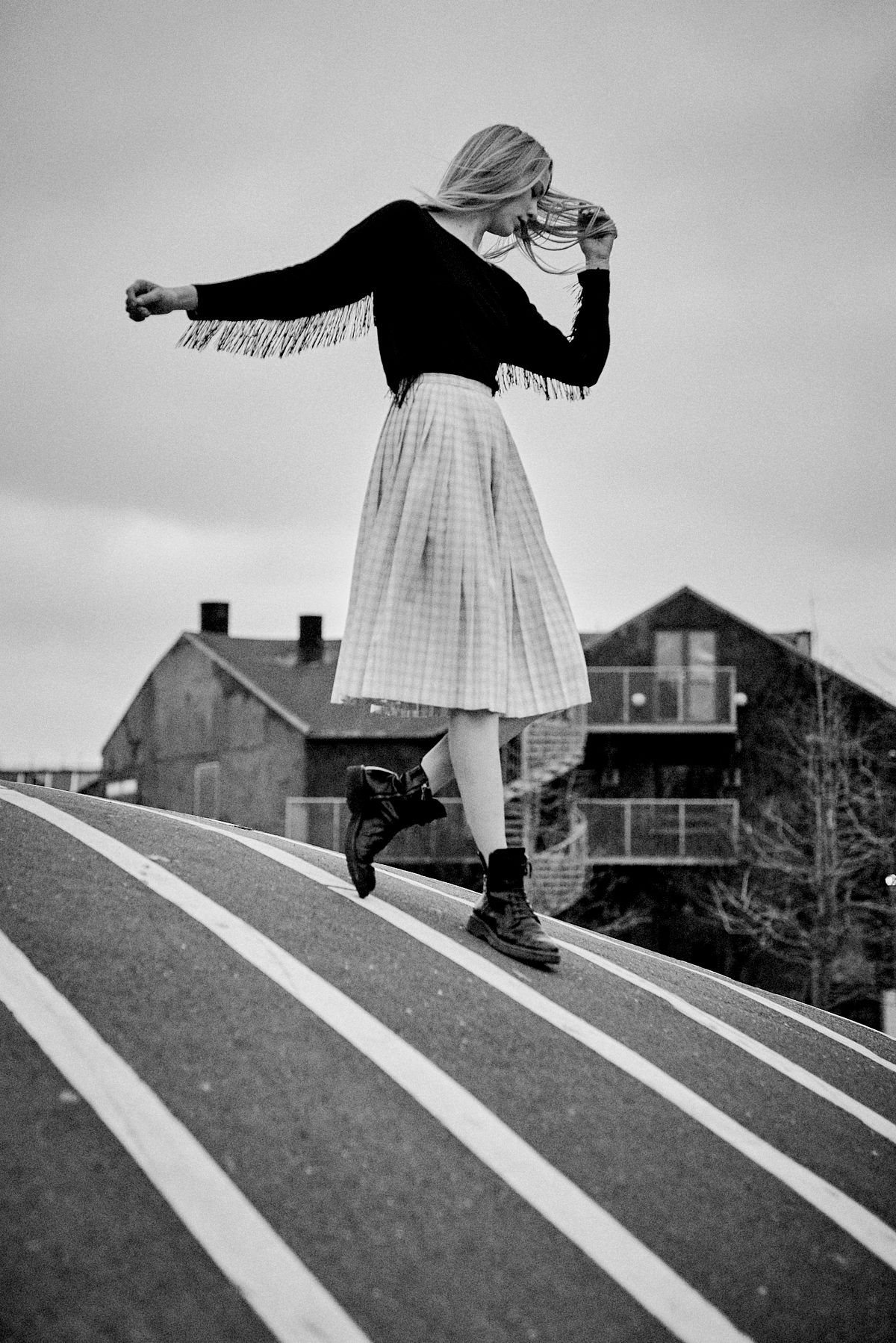 Cinematic black and white editorial of a woman in motion on a striped crosswalk in Copenhagen, by Gabriel Matula.