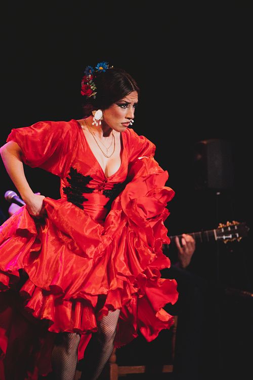 Flamenco dancer performing on stage in Jerez, expressive movement and dramatic lighting