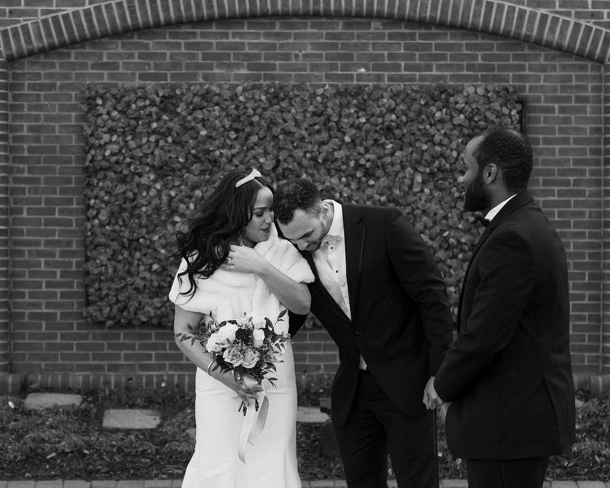 black and white photo of the bride and groom whispering to each other at baywood wedding venue
