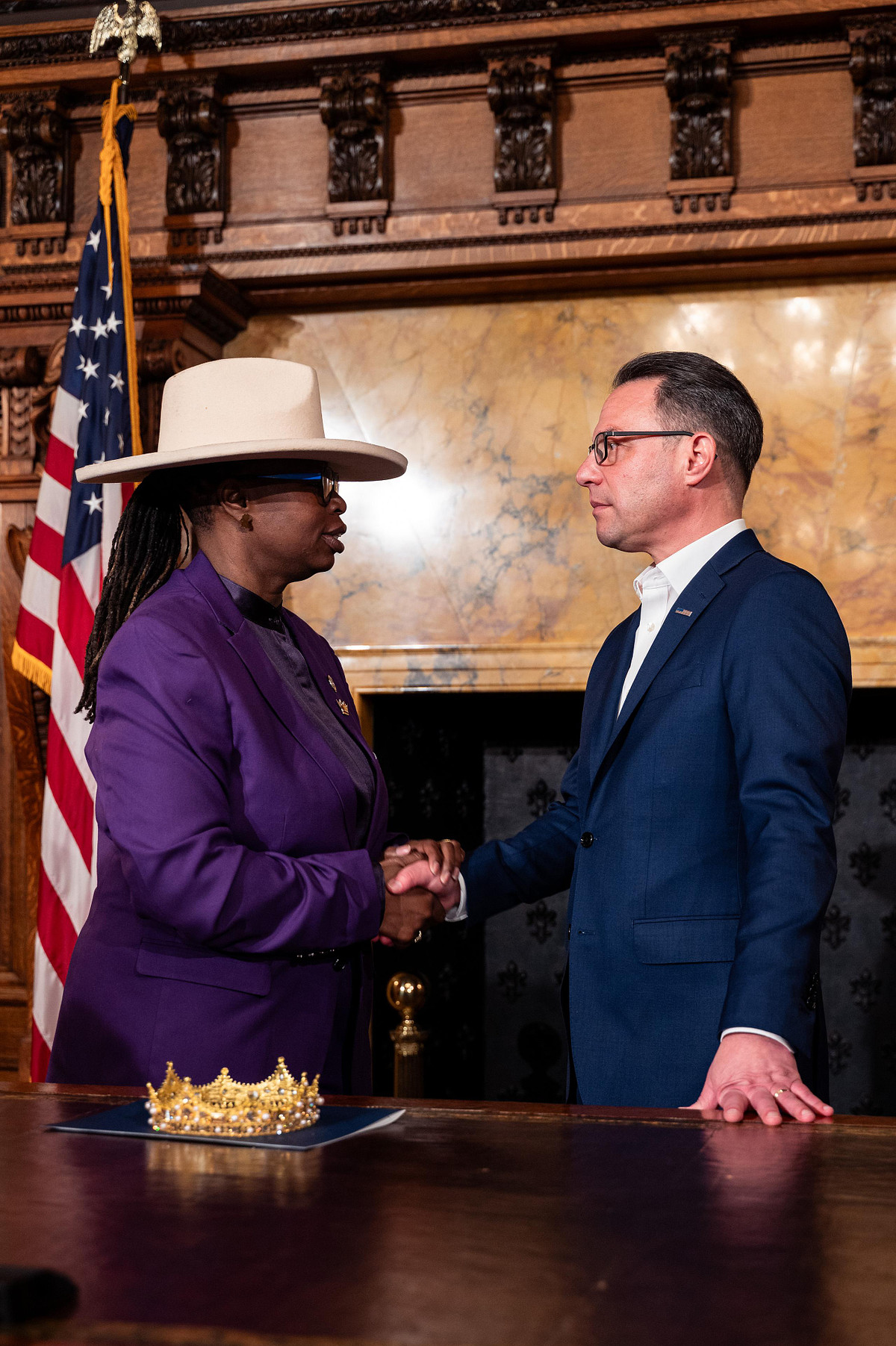 Governor Josh Shapiro shakes hands with a CROWN Act advocate following the bill signing in Pennsylvania