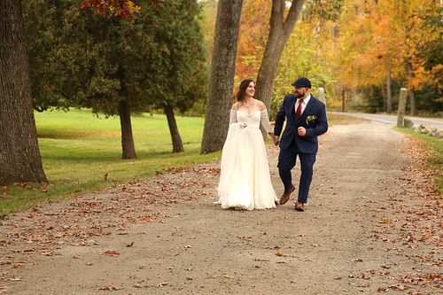 Married couple strolling and laughing on their wedding day
