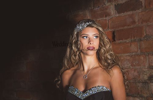 Close-up of a model in a black wedding dress from Bridal Re-Loved Leicester, looking sideways, photographed by Weddings by Jermaine, with hair and makeup by Justaboutweddingshair and beauty, and accessories by Sydney Grace Bridal