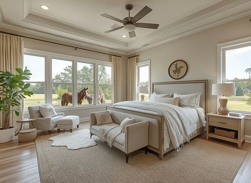 Professional real estate photography of a luxury master bedroom in Gainesville FL, featuring a tray ceiling, large windows with natural light, and neutral staging by PrimePropertyPhoto.