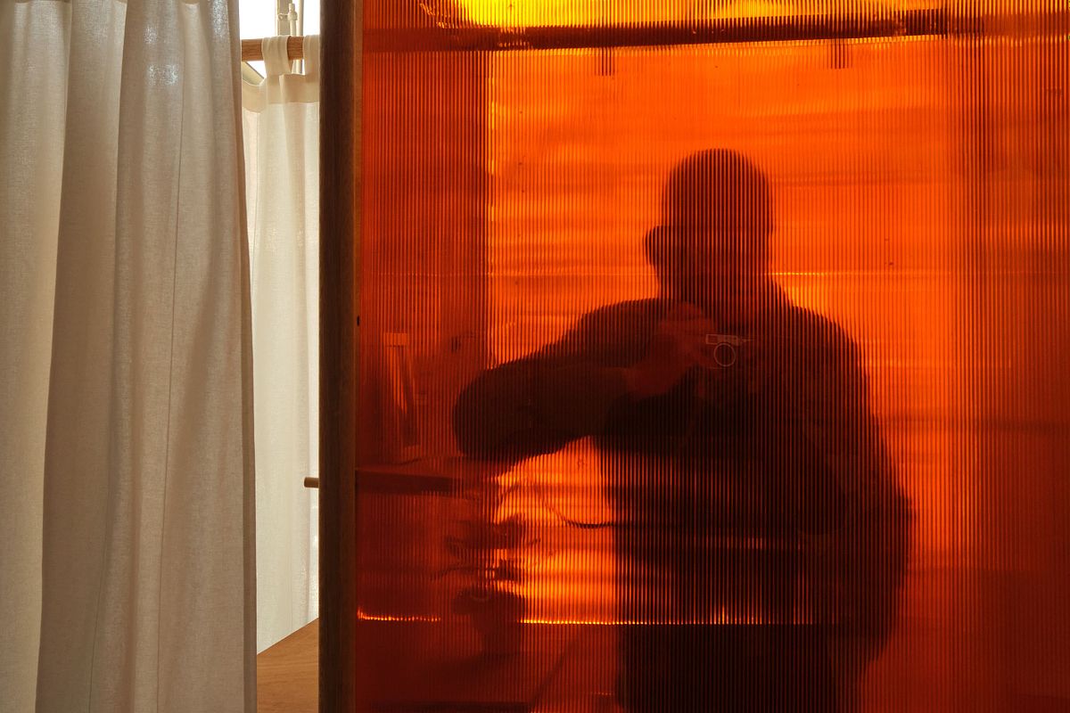 Beach chairs and windbreaks in pastel colors on a sandy beach, captured by photographer Sandeep Gajula