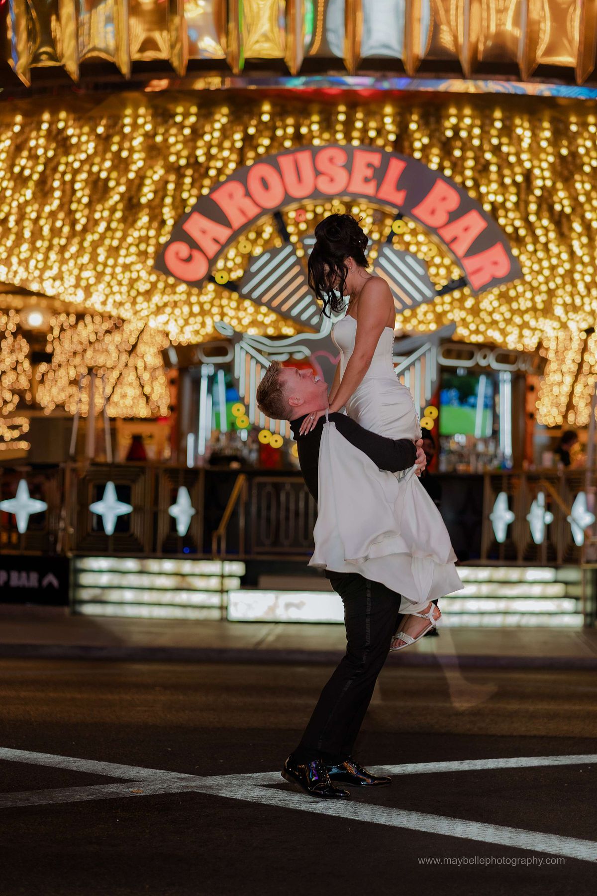 Romantic elopement photos at Carousel Bar in Downtown Las Vegas with couple celebrating with champagne