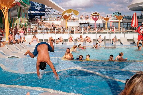 color film photo of man doing a cartwheel on a cruise ship