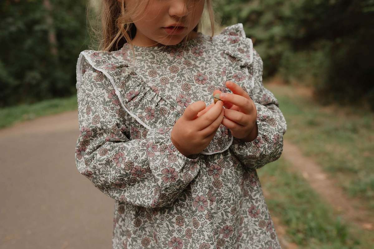 Young girl in pink floral blouse, close up children's portrait photography Northamptonshire