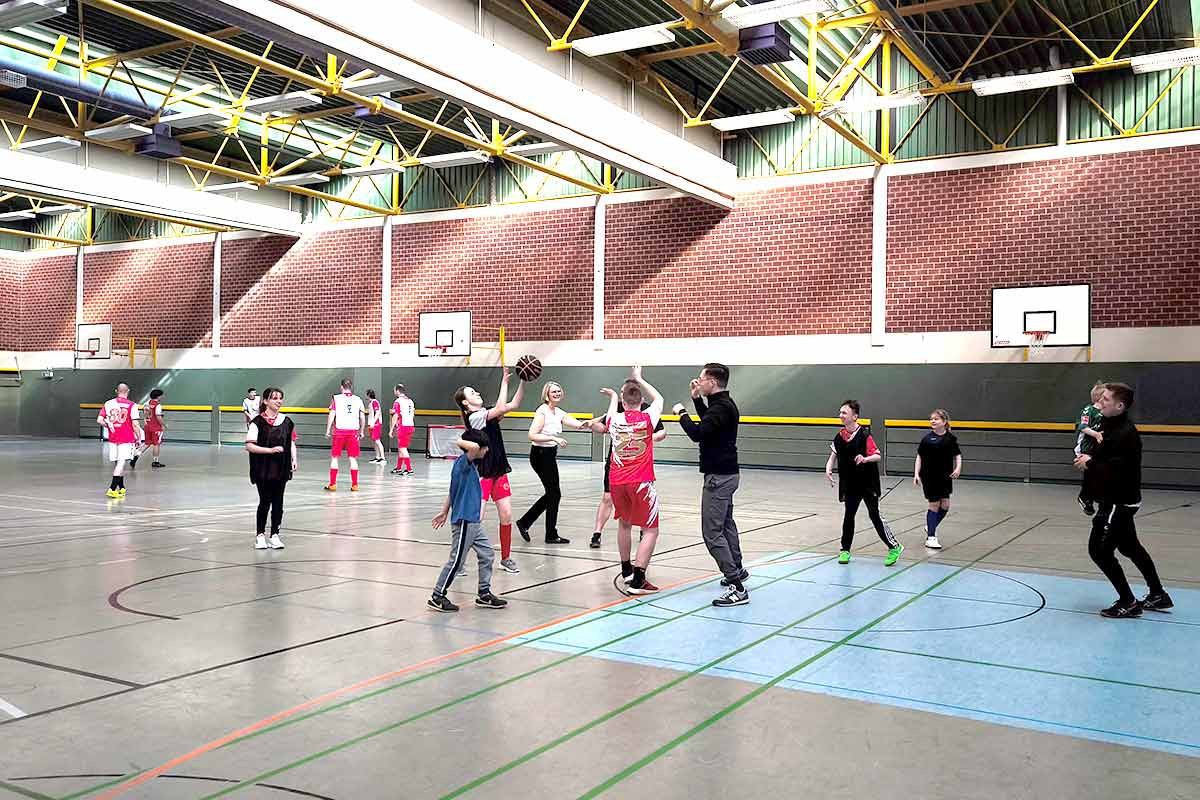 Aufgeteilte Spielfelder mit Basketball, Handball und Fußball beim Kickers-Training