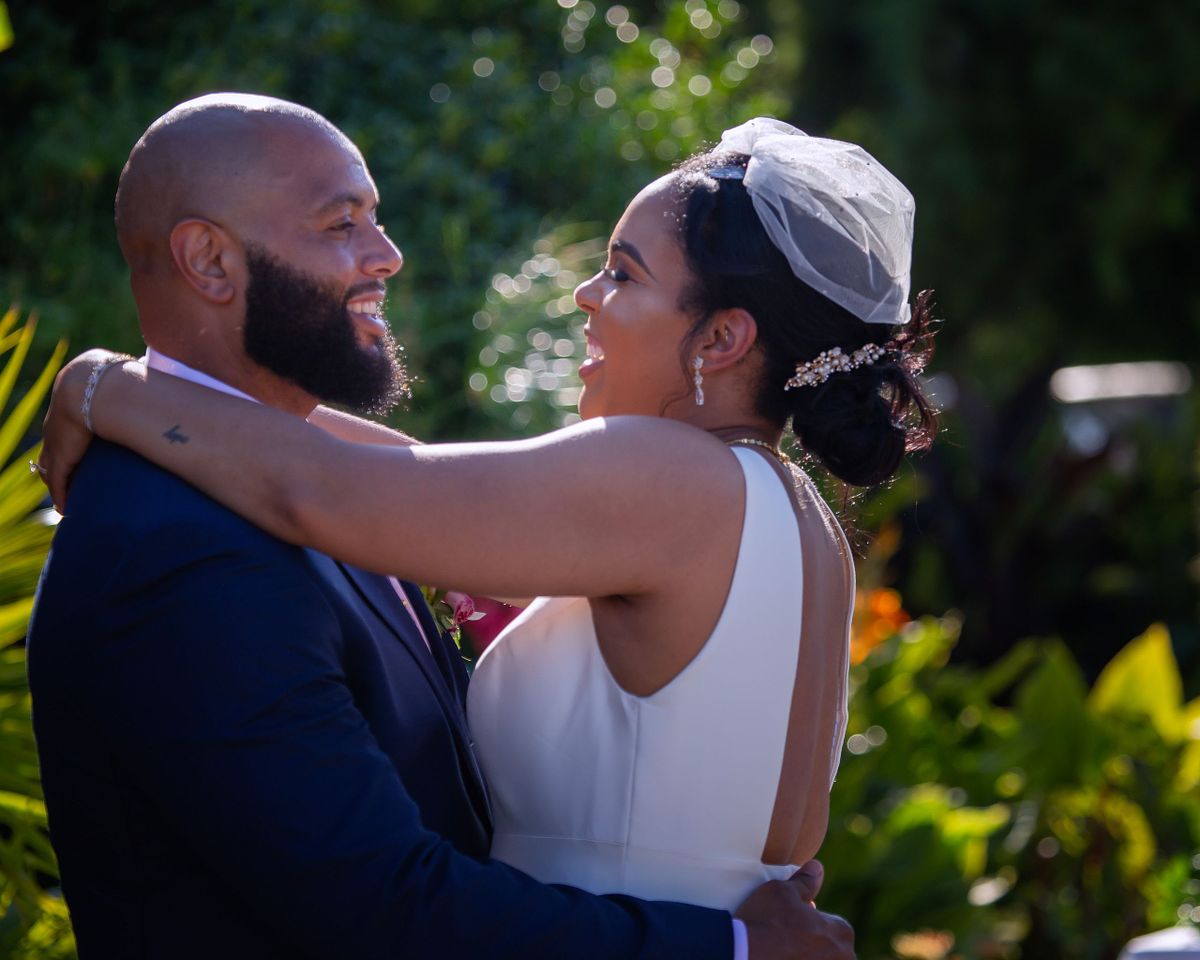 close-up of bride and groom dance the first dance, both are smiling and are happy