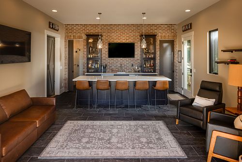 Overall view of Man Cave showing leather couch and armchairs