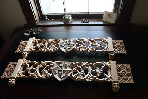hand-carved panels for shelves to hold relics in a convent chapel with Dominican Shields and scrolling vines