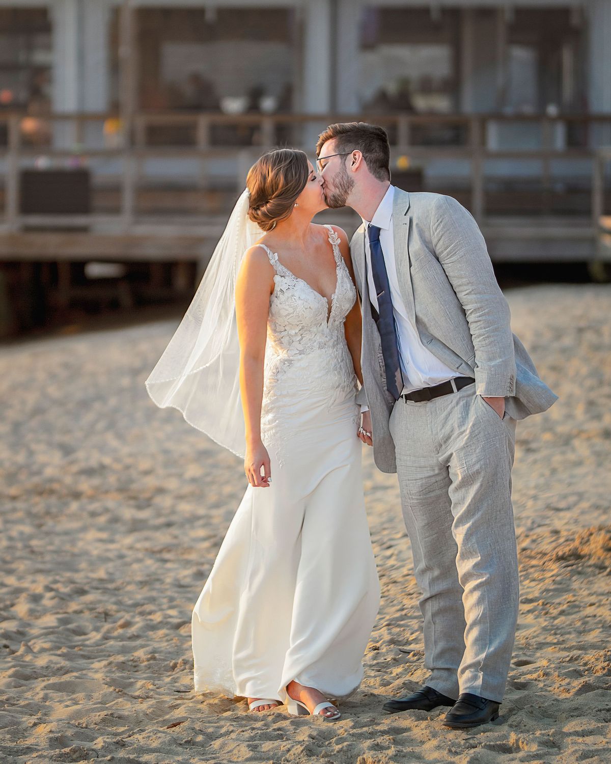 bride and groom kissing in dewey beach on the beach