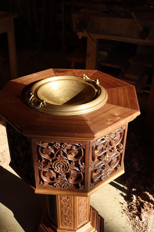 detail of the upper part of the baptismal font showing the beauty of the walnut