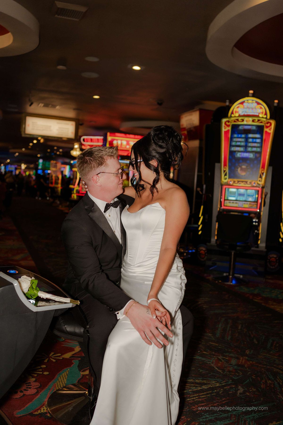 Romantic elopement photos at Carousel Bar in Downtown Las Vegas with couple celebrating with champagne