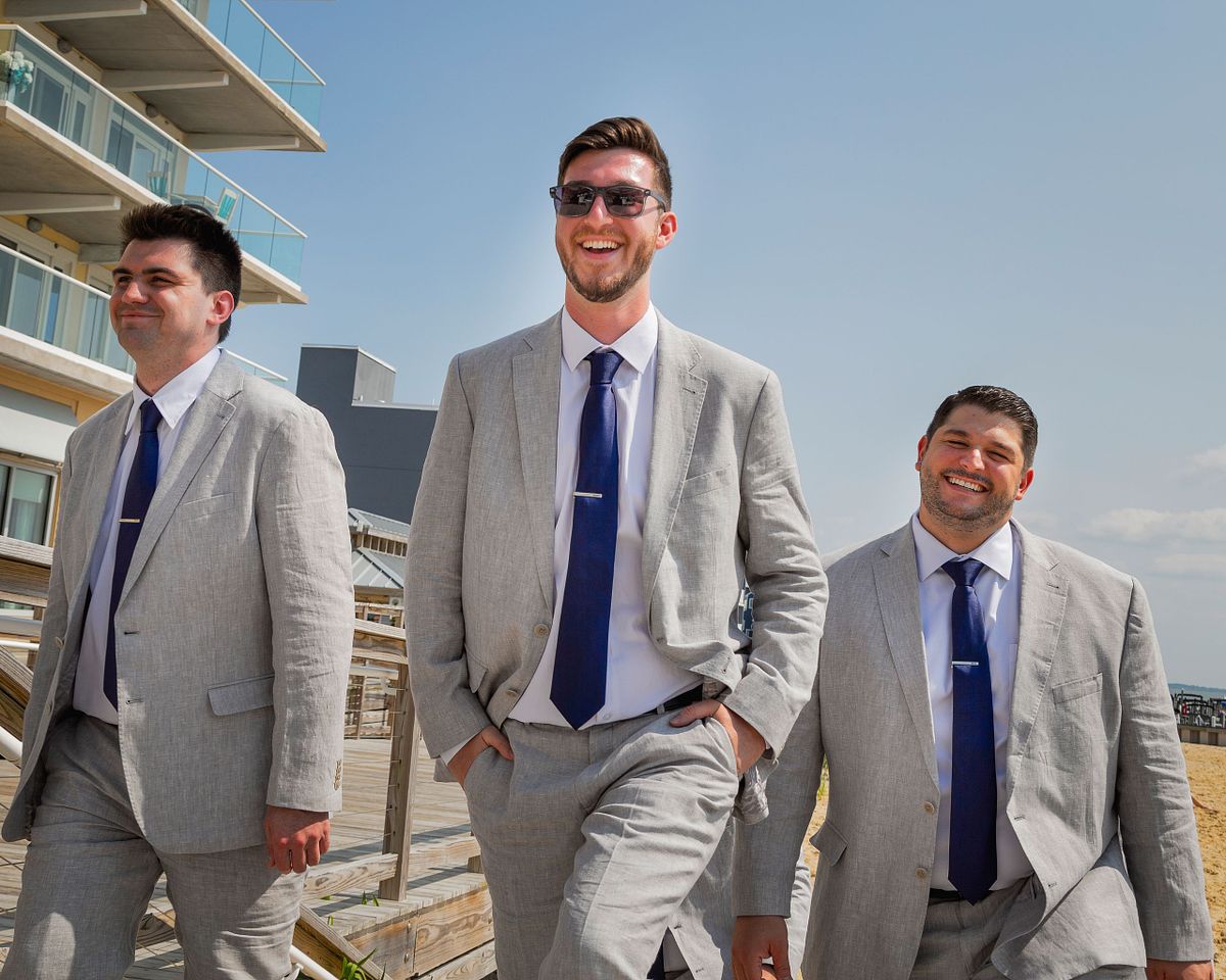 Groom with groomsmen on the beach in dewey beach, delaware